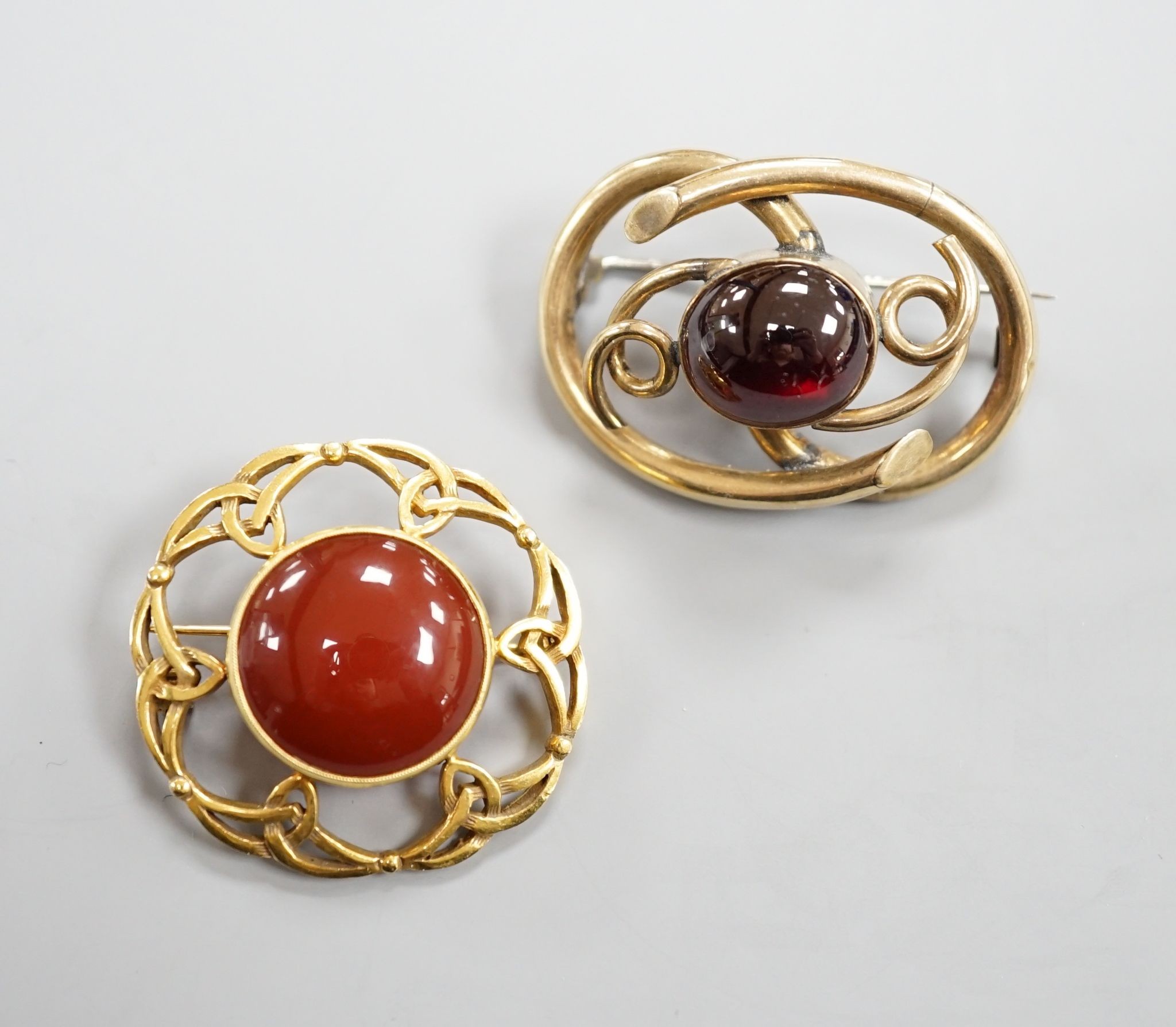 A late Victorian Scottish 9ct gold and carnelian set Iona brooch, 36mm, gross 10.1 grams and a Victorian mourning brooch.